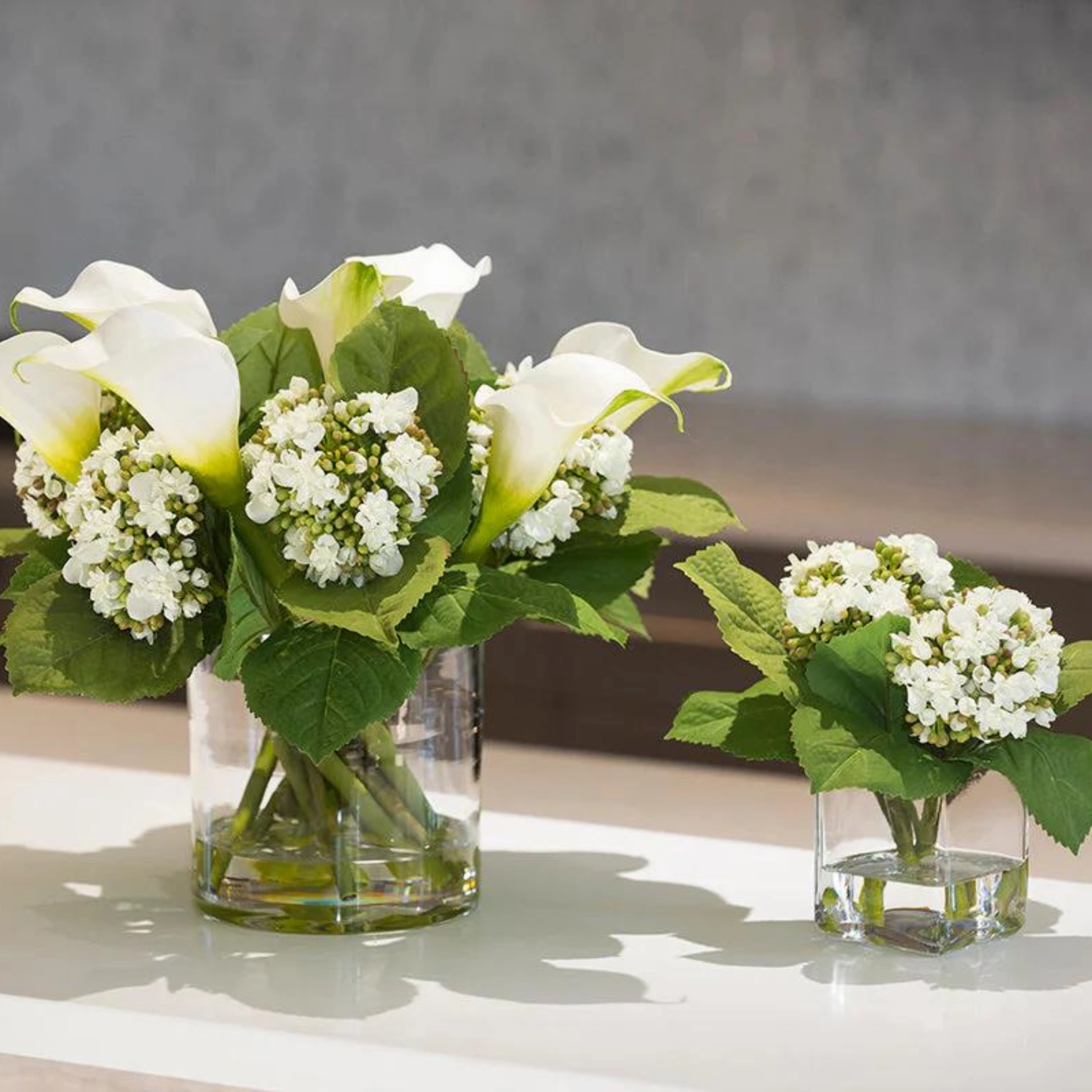 Calla Lily & Hydrangea White Buds Arrangement in Clear Cylinder Vase