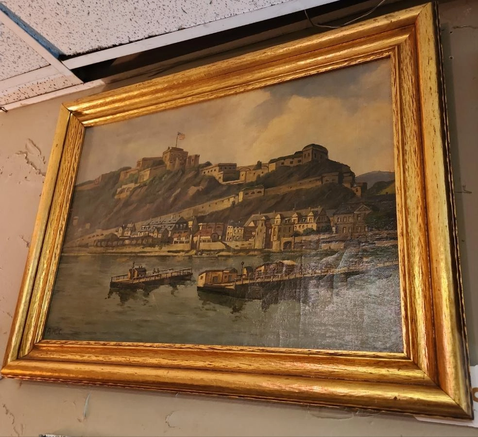 FRAMED OIL PAINTING OF A US MILITARY BASE ON THE WATER