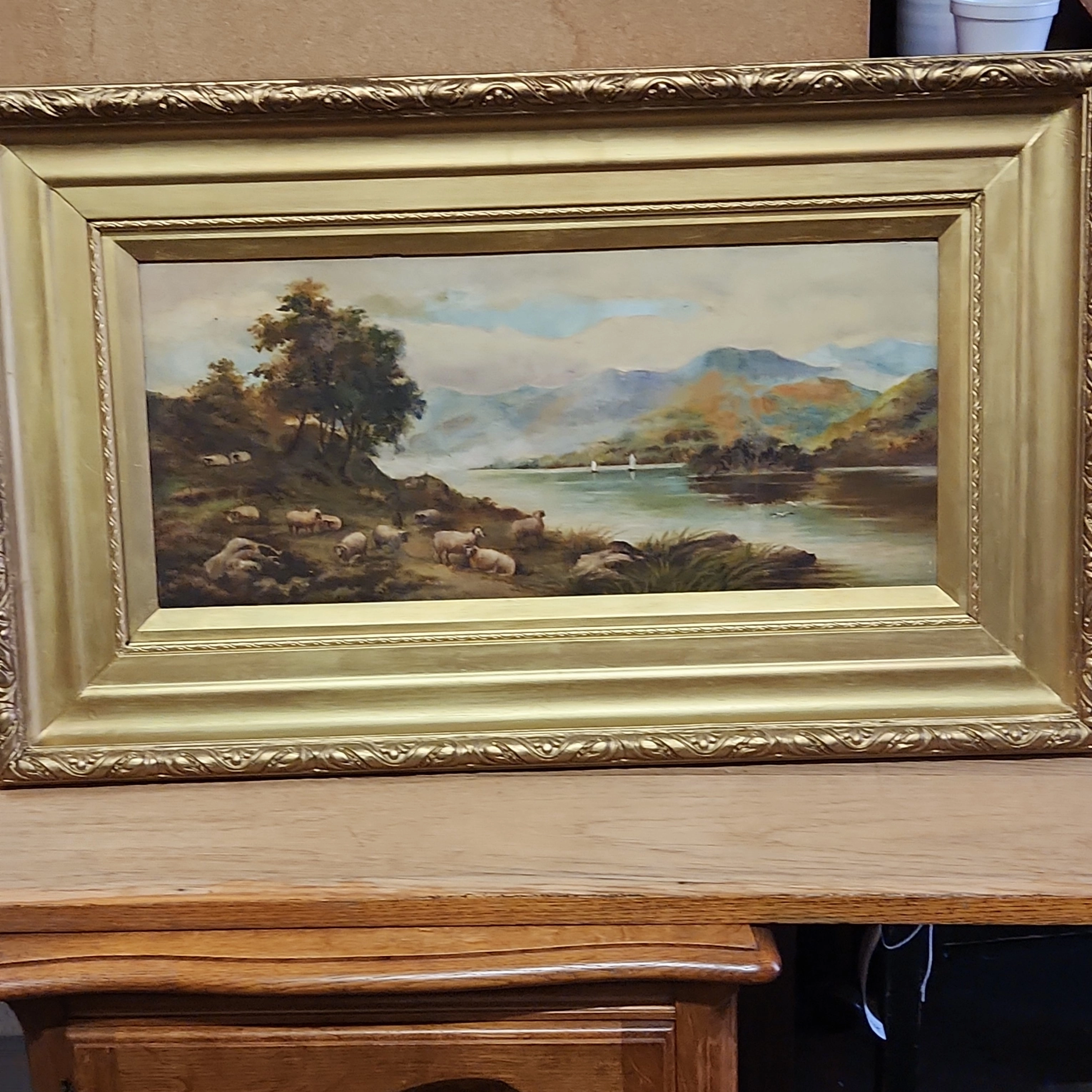 GOLD FRAMED OIL PAINTING OF A FLOCK OF SHEEP BY A LAKE-SIGNED