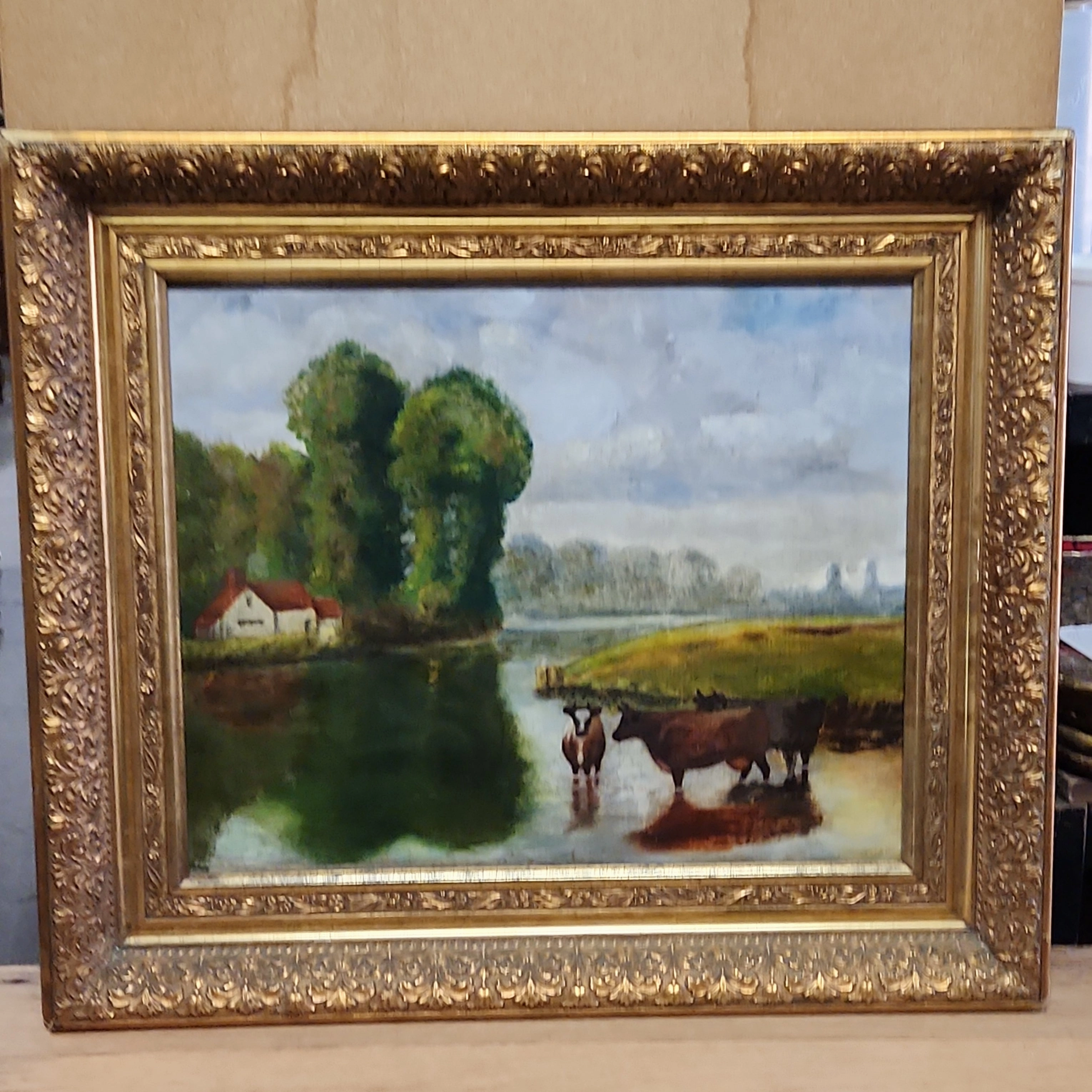 GOLD FRAMED OIL PAINTING OF COWS IN A RIVER BEND