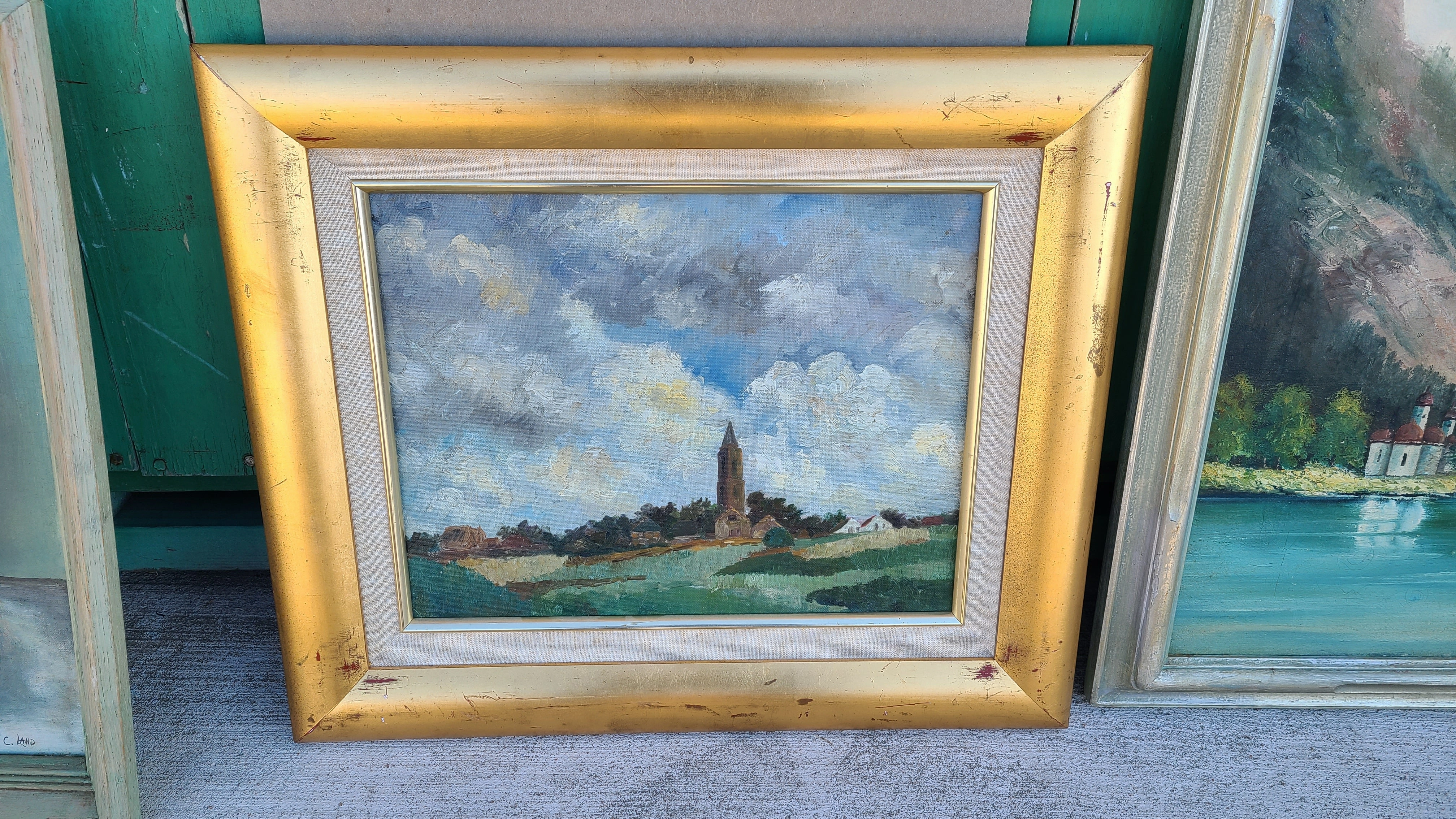 OIL PAINTING OF A CHURCH ON A HILL WITH GREAT CLOUDS