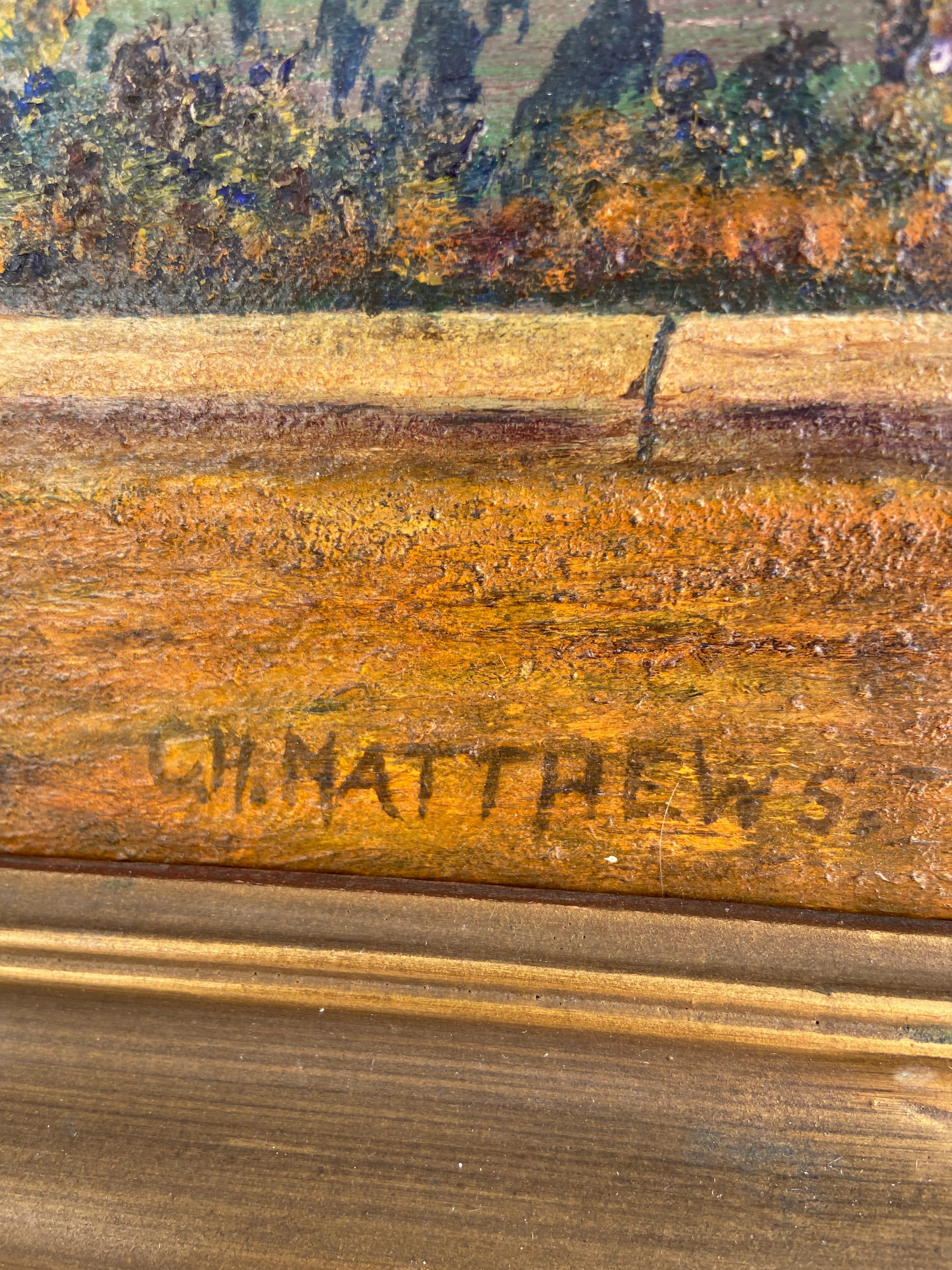 OIL PAINTING OF A LAKE SHORE WITH TREES AND A BENCH BY C. H. MATTHEWS