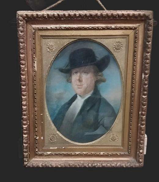 ORNATELY FRAMED WATERCOLOR OF A MAN WEARING A HAT