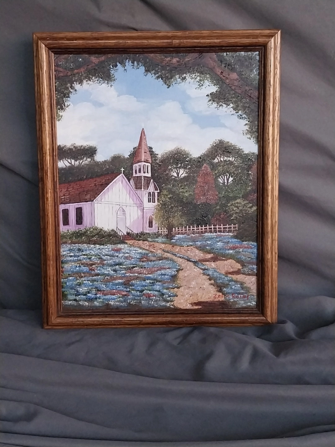 SMALL FRAMED OIL PAINTING OF CHURCH WITH BLUEBONNETS